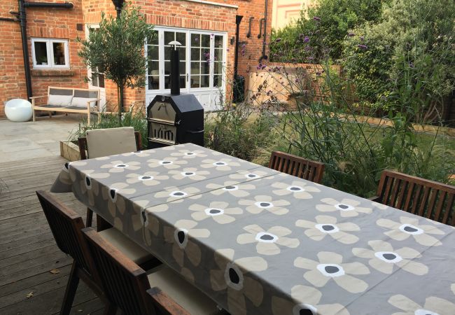 Gothic Cottage Holiday Home garden dining area with 12 seater table and pizza oven.