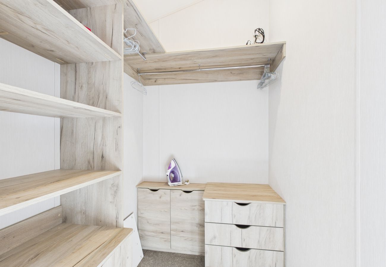 Organised shelving and hanging space within a private dressing area.