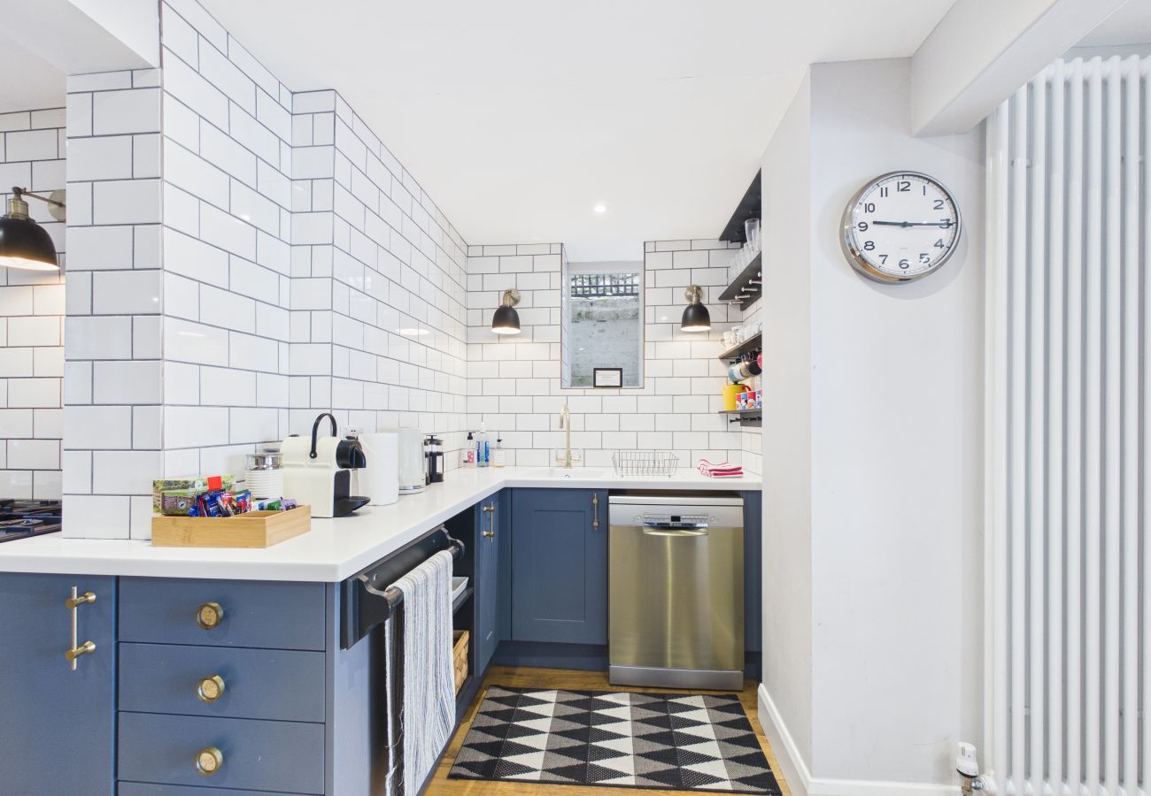 Sleek kitchen units with a large oven and a dining area.