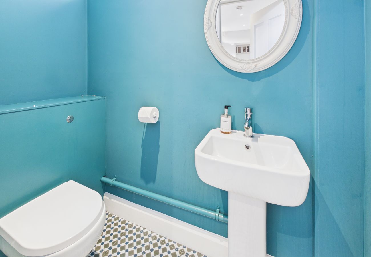 A practical second cloakroom located near the utility room and garden entrance.