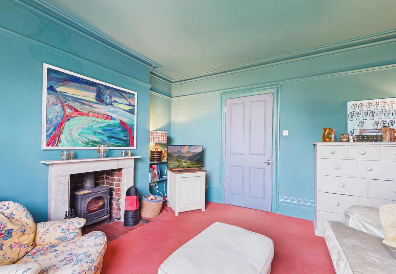 A cozy sitting room with smart TV looking out over the private garden.
