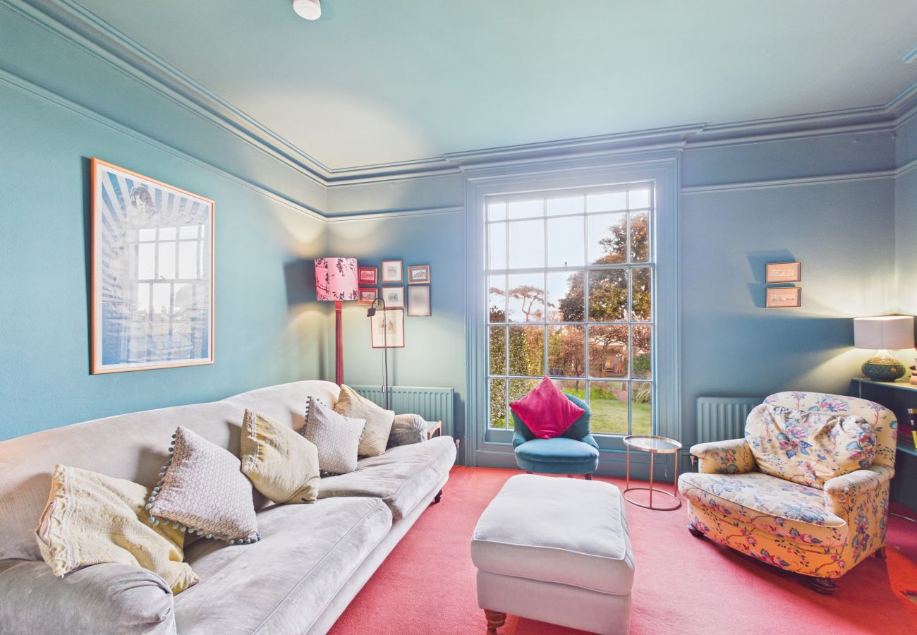 A cozy sitting room with twin armchairs looking out over the private garden.