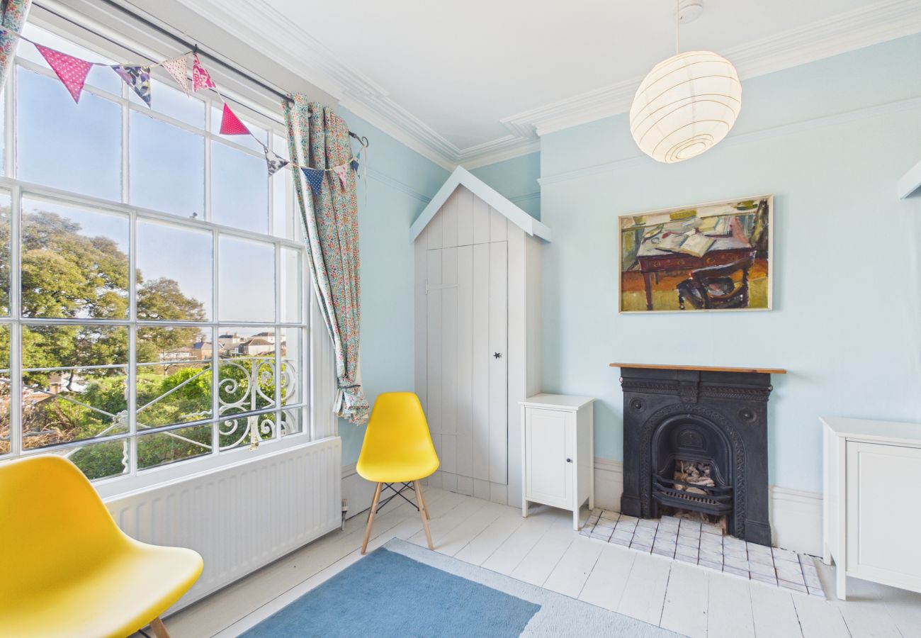Wooden bunk beds with colorful bedding in a characterful guest room.
