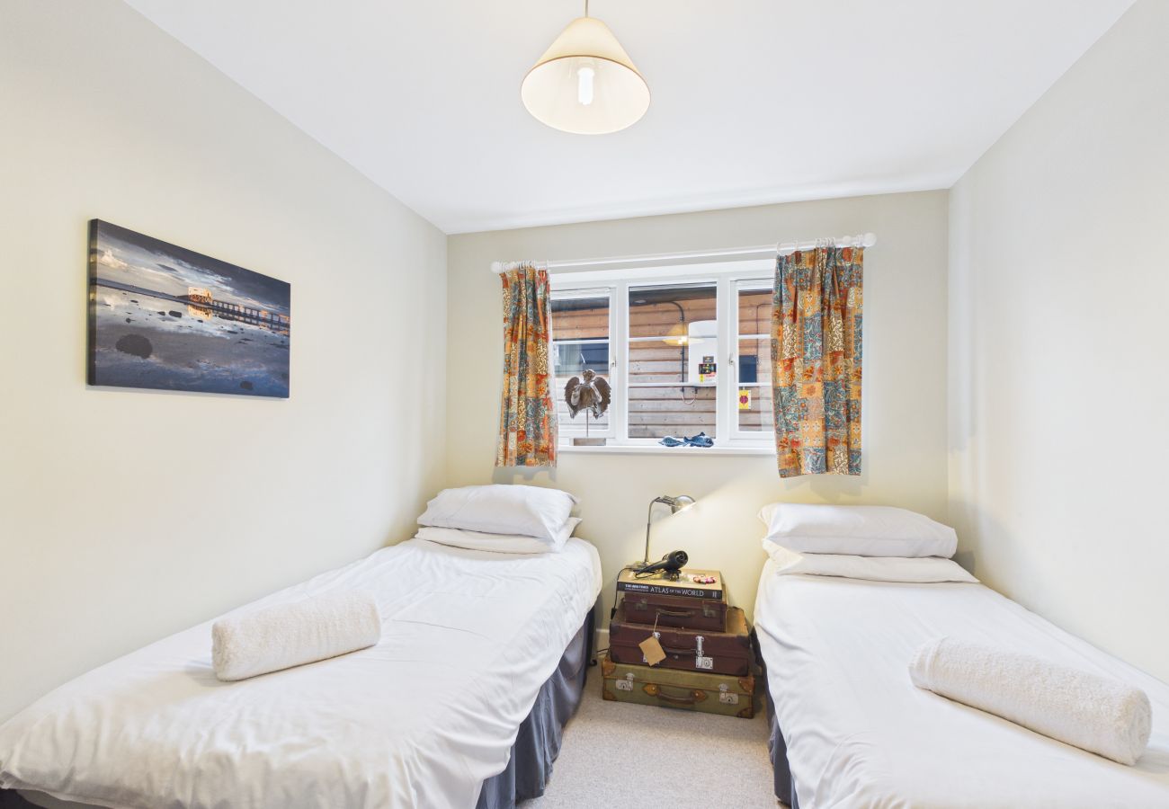 Twin bedroom with two single beds at The Timbers eco-luxe holiday home