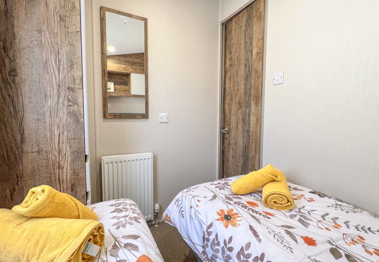 Family-friendly twin bedroom with stylish décor, offering a cozy space for children or extra guests