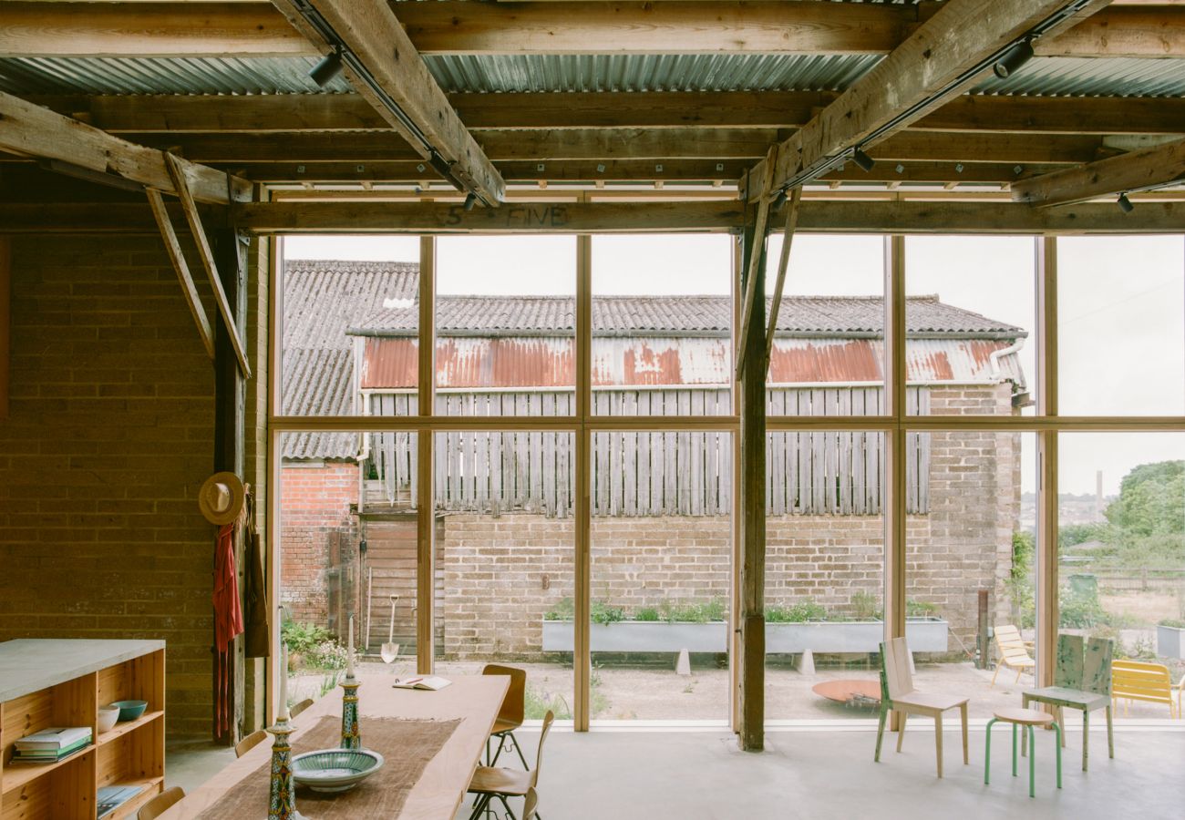 Sleek minimalist kitchen with a large central island and breakfast bar in a holiday rental.